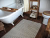 The Bathroom has a Rolltop Bath with Shower Above and a Memorable View Across the Hills